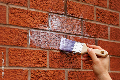 Applying Waterproof Sealant to a Brick Wall