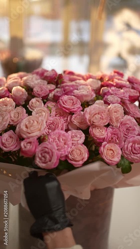 Large bouquet of pink roses wrapped in gift paper. Concept flower arrangement.