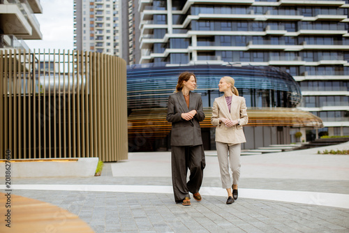 Two women walk together in ...
