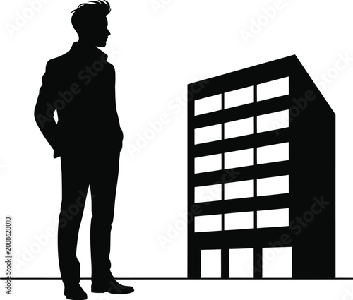 Silhouette of a man standing in front of a modern office building