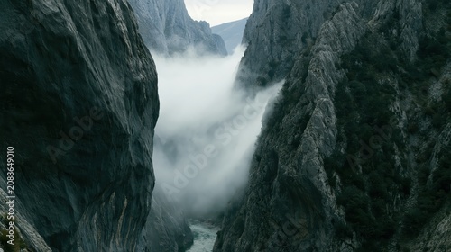 Misty Mountain Canyon With Dark Cliffs and Narrow River