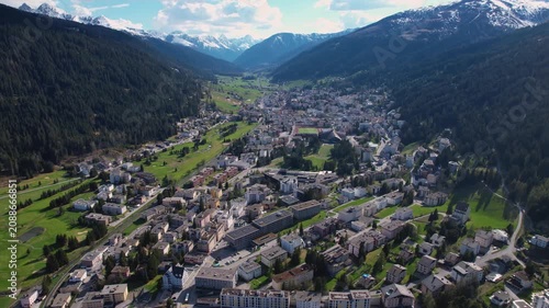Aerial panoramic view above the downtown around the city Davos in Switzerland on a sunny summer afternoon. 