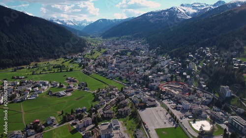 Aerial panoramic view above the downtown around the city Davos in Switzerland on a sunny summer afternoon. 