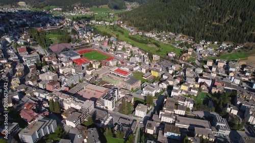 Aerial panoramic view above the downtown around the city Davos in Switzerland on a sunny summer afternoon. 