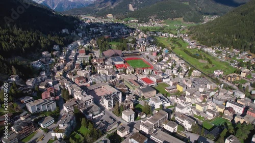 Aerial panoramic view above the downtown around the city Davos in Switzerland on a sunny summer afternoon. 
