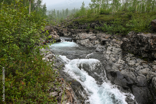 Mountain stream on a cloudy summer day.