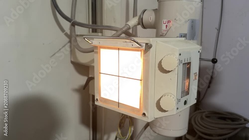 Collimator projects crosshair light field to align radiation beam on medical X‑ray machine. 