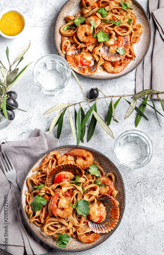 Seafood pasta. Fettucini wish scallops in a table setting.