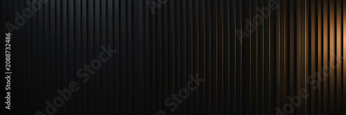Vertical black corrugated metal wall with warm side lighting