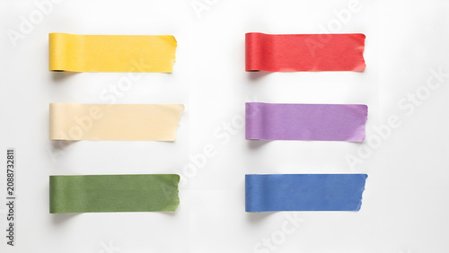 Six strips of colorful masking tape arranged in two columns on white