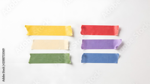 Six rectangular strips of colored masking tape arranged on a white background