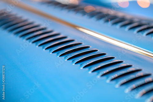 Bild auf Leinwand Blue classic Morgan hood louvers forming elegant automotive pattern