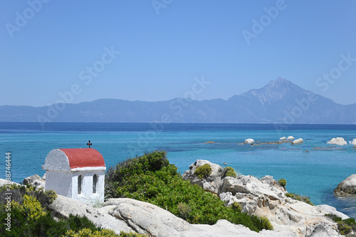 Canvastavla Small traditional greek shrine on the rocks of Orange Beach with Mount Athos vie