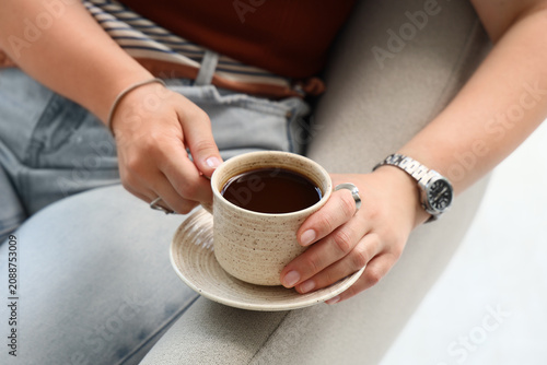 Person holding a cup of bla...