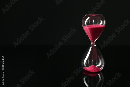 Crystal hourglass on dark  ...