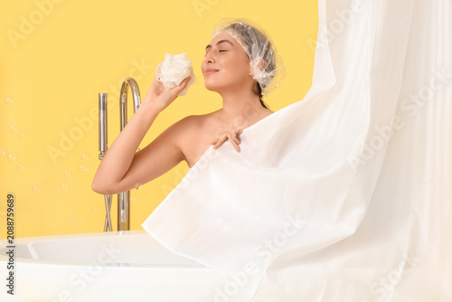 Young woman in bathtub with...