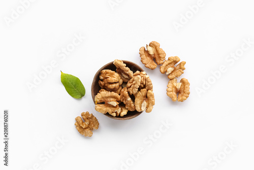 Bowl of tasty walnuts on wh...