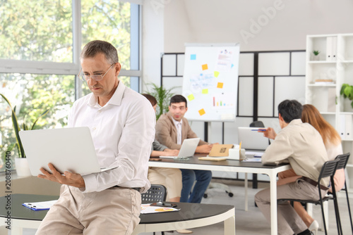 Mature businessman working ...
