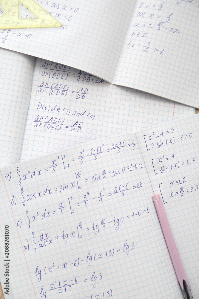 Obraz premium Open copybooks with math formulas as background, closeup