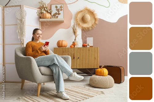 Young woman sitting in cozy...