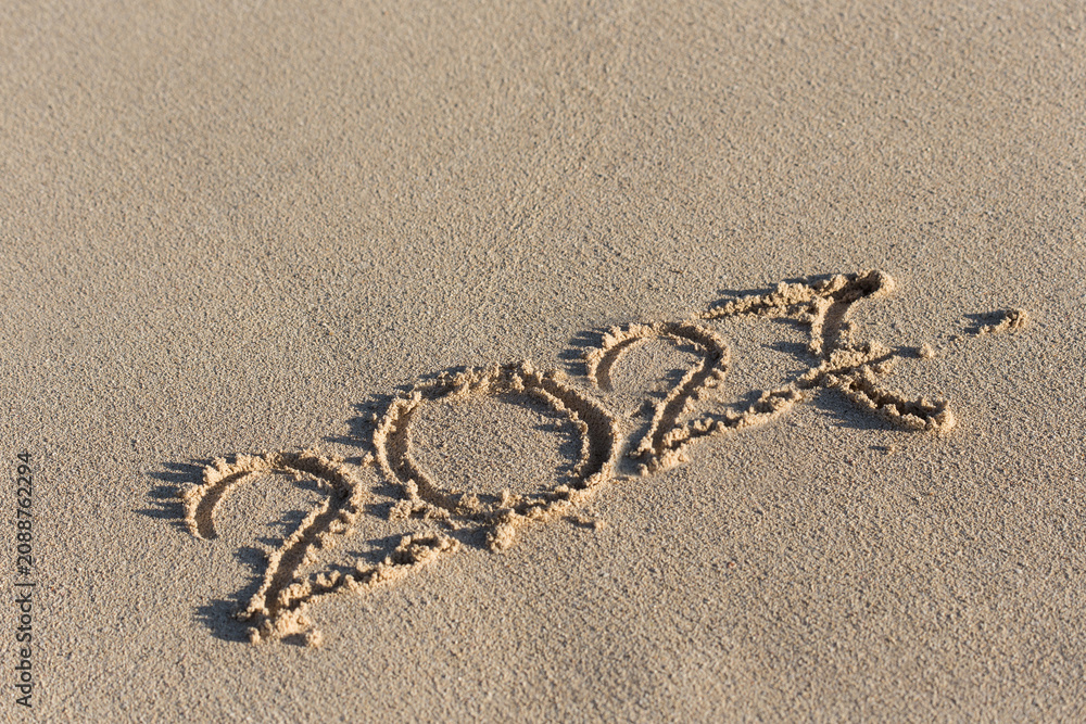Fototapeta premium Inscription 2027 on sandy beach. Celebration of new year