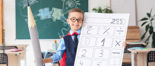 Young boy in classroom hold...