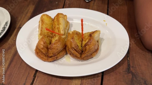 Tasting a Crispy Buttered Pastry with Sweet Syrup on Plate
