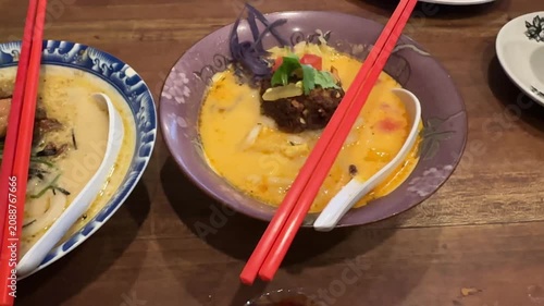 Savoring a Creamy Brothy Bowl with Toppings and Chopsticks