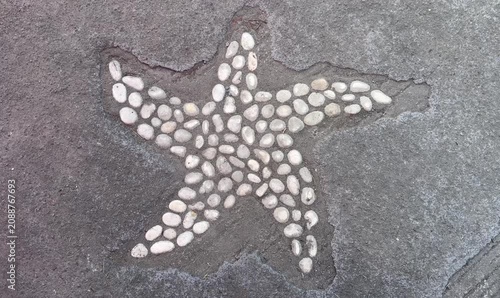 Moving Star Pattern On Pavement Assembled With Pebbles