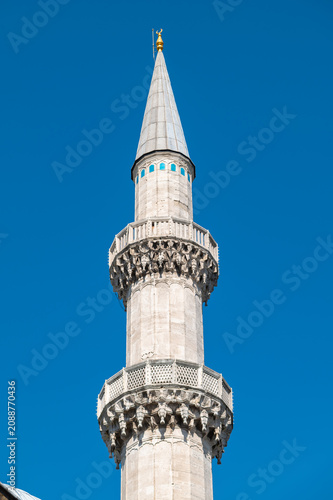 Vertical photo of a tower minaret of an ottoman mosque in istanbul.