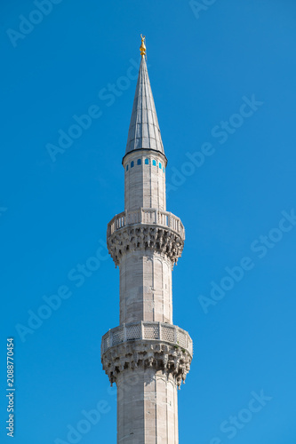 Vertical photo of a tower minaret of an ottoman mosque in istanbul.