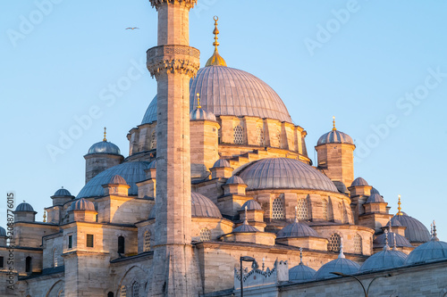Horizontal photo of a ottoman mosque with their domes and minaret.