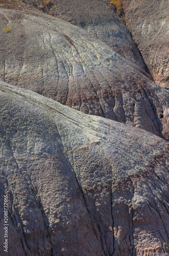 Curved, gray rock formations with cracks, rough texture and subtle color shifts