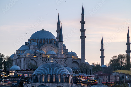 Horizontal photo of a ottoman mosque with the minarets and a clear sky at sunset.