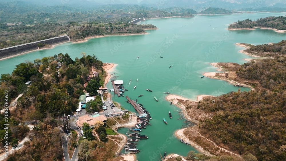 Fototapeta premium Khao sok lake aerial view with dam, lush forest and longtail boats