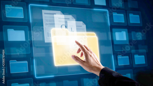 Person interacting with virtual files on a futuristic digital interface screen