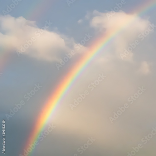 Rainbow appearing through clouds