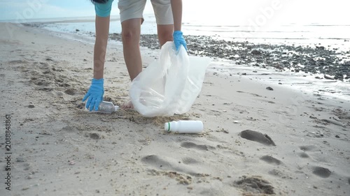 Save water. Volunteer pick up trash garbage at the beach and plastic bottles are difficult decompose prevent harm aquatic life. Earth, Environment, Greening planet, reduce global warming, Save world