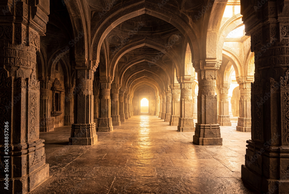 Obraz premium Processional pathway inside an ancient stone temple with tall pillars