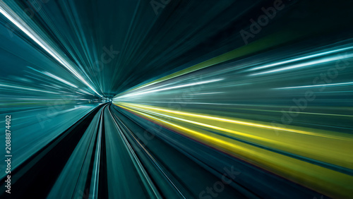Motion blur of subway train lights in a tunnel, abstract streaks of blue and yellow, suitable for speed, technology and futuristic concepts