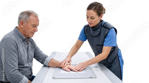 Professional Female Radiographer Positioning Elderly Patient Hand for X-ray Scanning Isolated
