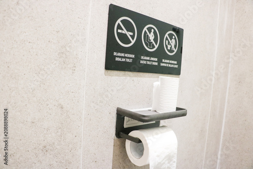 Fotografie Clear sign board in a modern toilet warning visitors against smoking and imprope