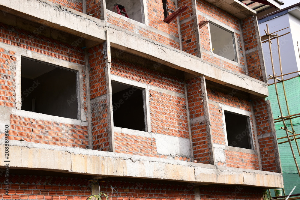 Obraz premium exterior view of brick house under construction with concrete structure