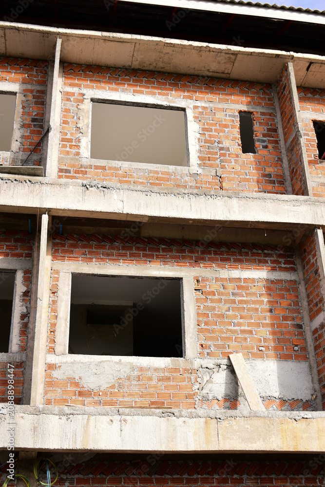 Obraz premium exterior view of brick house under construction with concrete structure