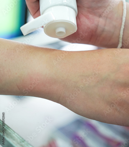 Pharmacist Demonstrating Topical Cream Dispensing on Patient Arm Vertical