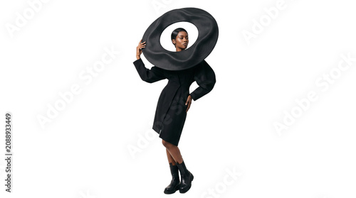 Fashionable Black Dress and Oversized Hat on a Woman
