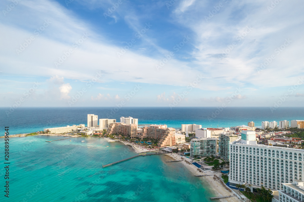 Fototapeta premium Aerial panoramic view of Cancun beach and city hotel zone in Mexico. Caribbean coast landscape of Mexican resort with beach Playa Caracol and Kukulcan road. Riviera Maya in Quintana roo region on