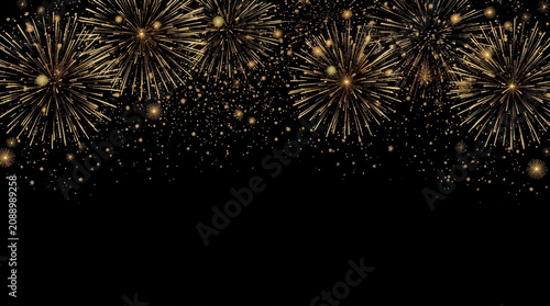 Golden fireworks burst over black sky creating festive sparkling celebration mood