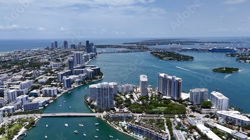 Aerial view of Miami skyline and waterfront islands over turquoise Biscayne Bay in sunny Florida, USA. g.