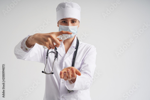 Tablou pe pânză doctor applying antibacterial spray on hand on white background